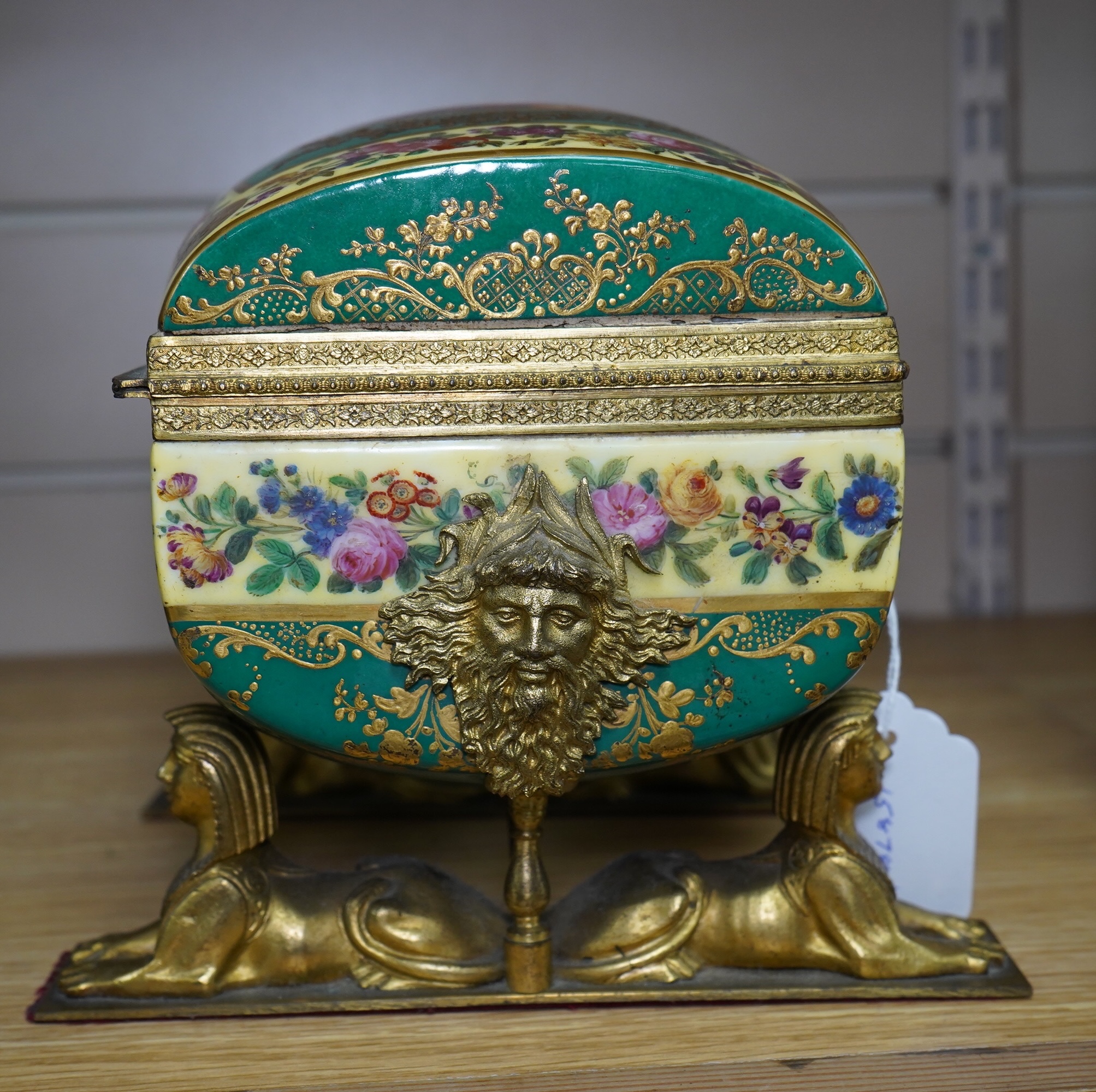 An early 20th century Sevres style sarcophagus shaped casket, on twin sphinx ormolu base, 24cm. Condition - good